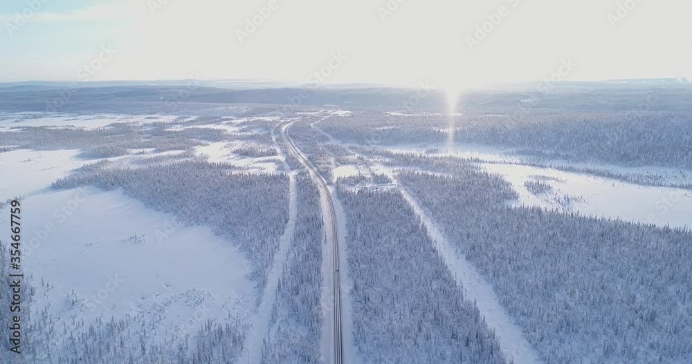 An aerial view shows a car driving down a tree-lined, snow-covered highway in Sweden. An aerial view shows a car driving down a tree-lined, snow-covered highway in Sweden.