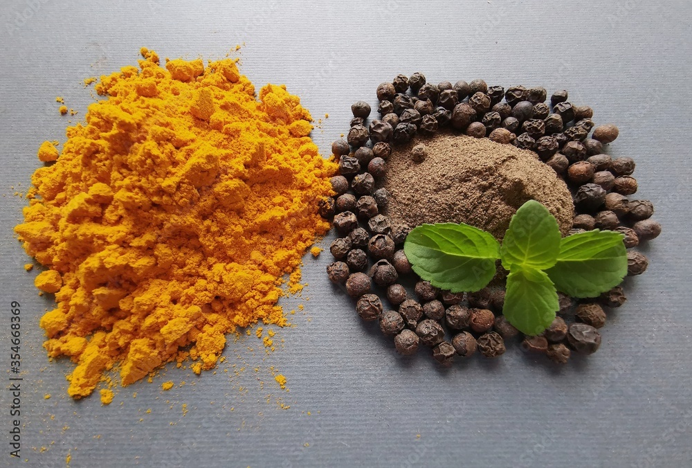 Turmeric powder (curcuma), black pepper corns and black pepper powder