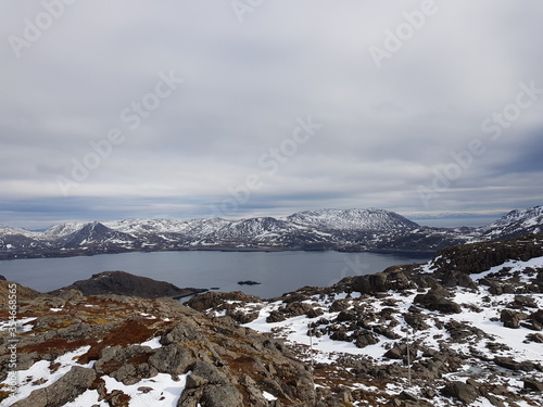 snowy mountain landscape and sea in nordkapp in early spring