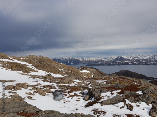 snowy mountain landscape and sea in nordkapp in early spring
