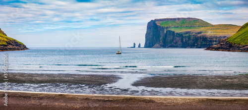 Panoramic summer view of Tjornuvik beach. SPlendid morning scene of Streymoy island with Eidiskollur cliffs on background. Impressive seascape of Atlantic ocean, Faroe Islands, Denmark. photo