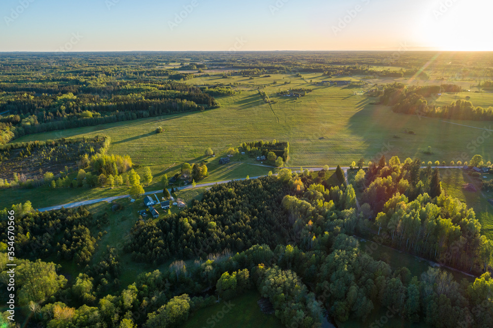 Naklejka premium Aerial view of amazing sunset at summer season. Nature landscape. Fields, rivers and trees.