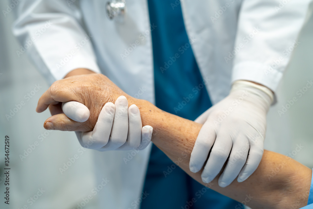Doctor holding touching hands Asian senior or elderly old lady woman patient with love, care, helping, encourage and empathy at nursing hospital ward : healthy strong medical concept