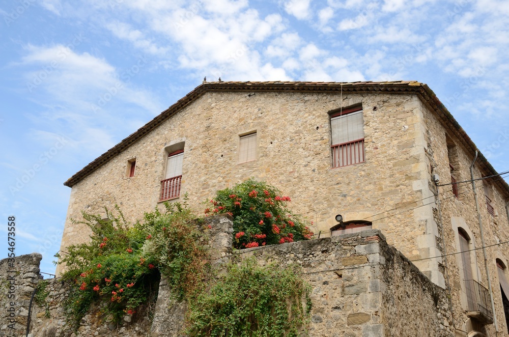 Flowers on stone house in Besalu, Girona, Spain