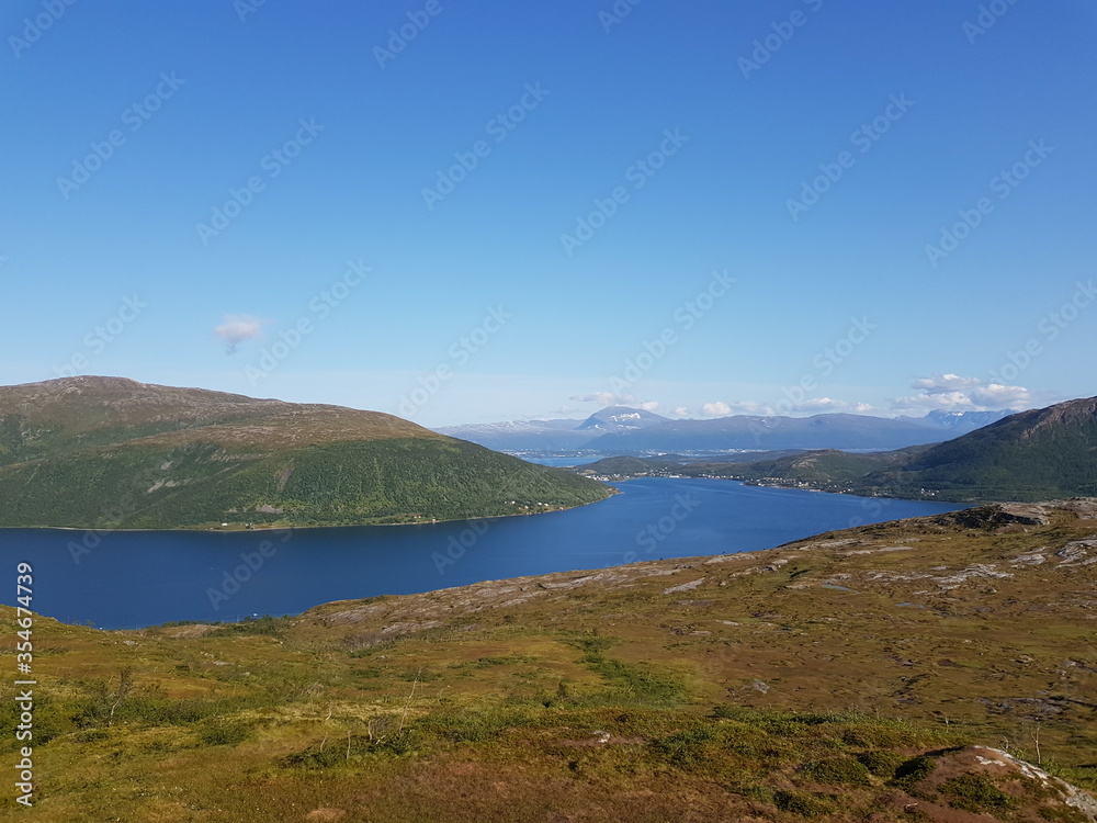 landscape with mountains and blue sky and ocean in northern norway on the whale island