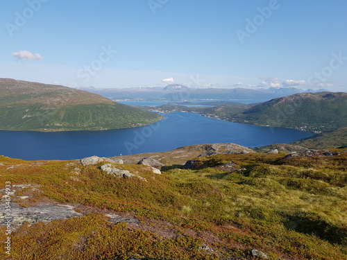 landscape with mountains and blue sky and ocean in northern norway on the whale island © Arcticphotoworks