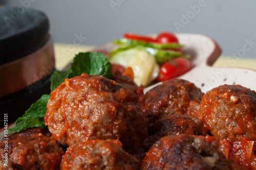 delicious meatballs with tomato sauce and salad