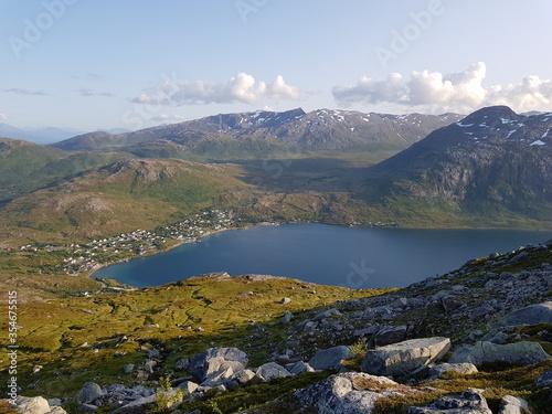 mighty sea and small settlement view from mountain top overlooking kvaloya island in northern Norway in summer