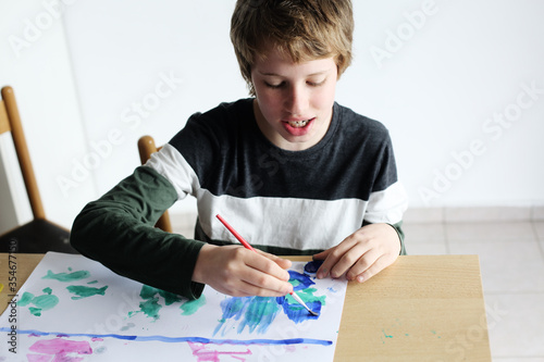 Cute 12 years old autistic boy drawing