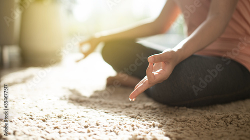 Close up woman hands meditating yoga or lotus pose on carpet, people practicing yoga early morning