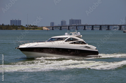 High-end cabin cruiser, white with black trim on the Florida Intra-Coastal Waterway.