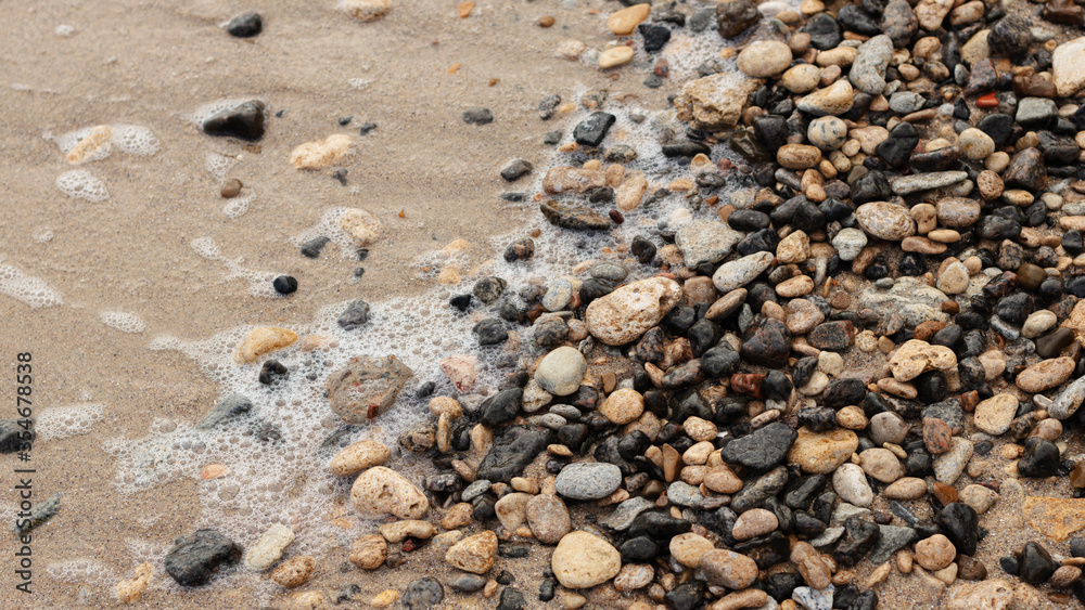 Different texture on the beach - water and sand, stones and pebbles, waves and splashes. Different texture on the beach - water and sand, stones and pebbles, waves and splashes.