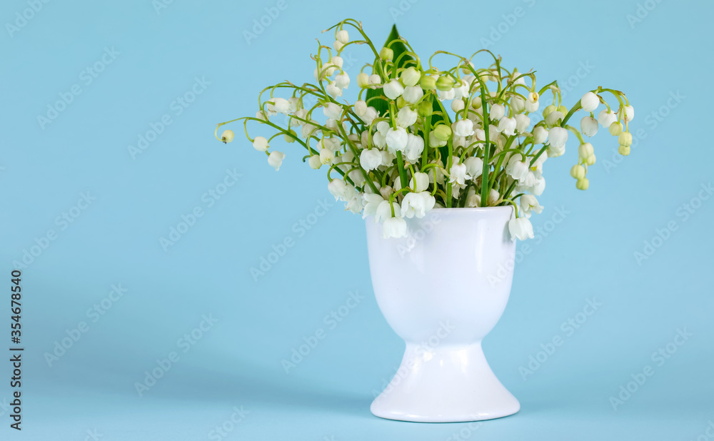 A bouquet of lilies of the valley in an egg stand A bouquet of lilies of the valley in an egg stand