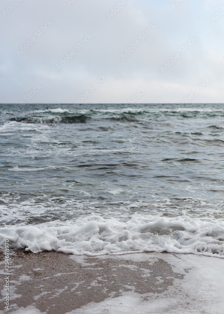 Different texture on the beach - water and sand, stones and pebbles, waves and splashes. Different texture on the beach - water and sand, stones and pebbles, waves and splashes.