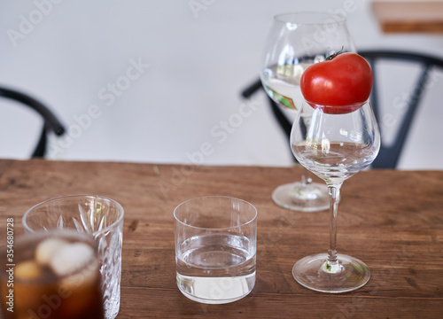 glasses on a wooden table with cherry iced coffee