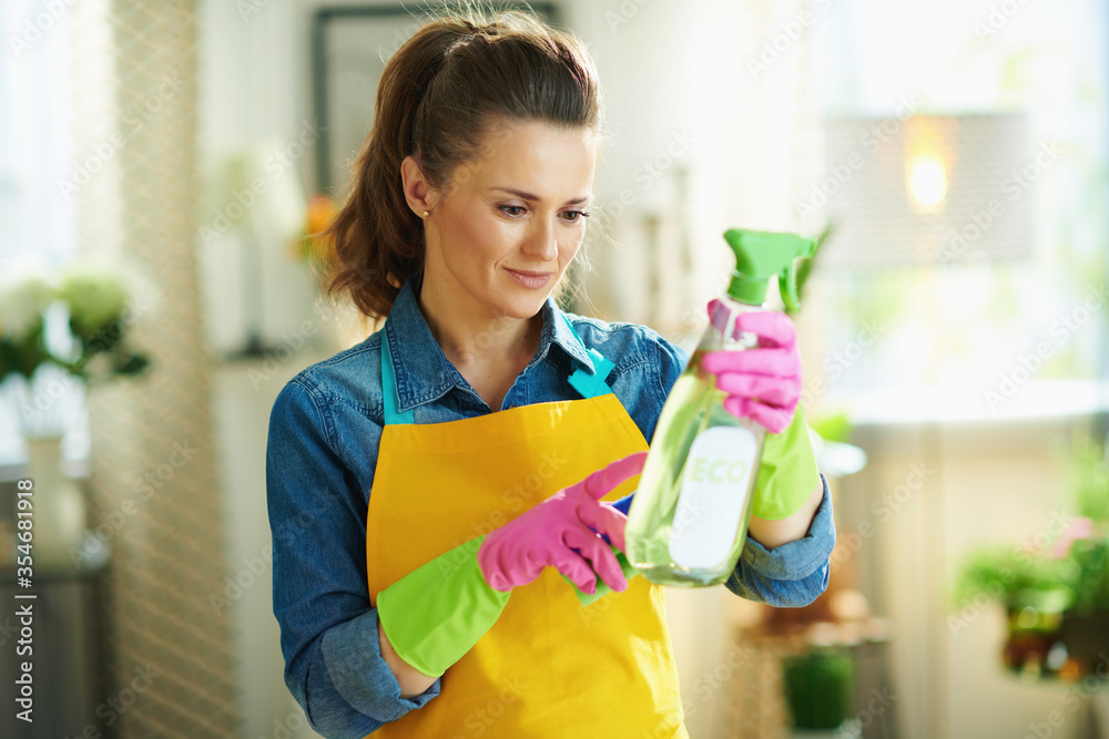 40 years old woman with cleaning agent reading instruction 40 years old woman with cleaning agent reading instruction