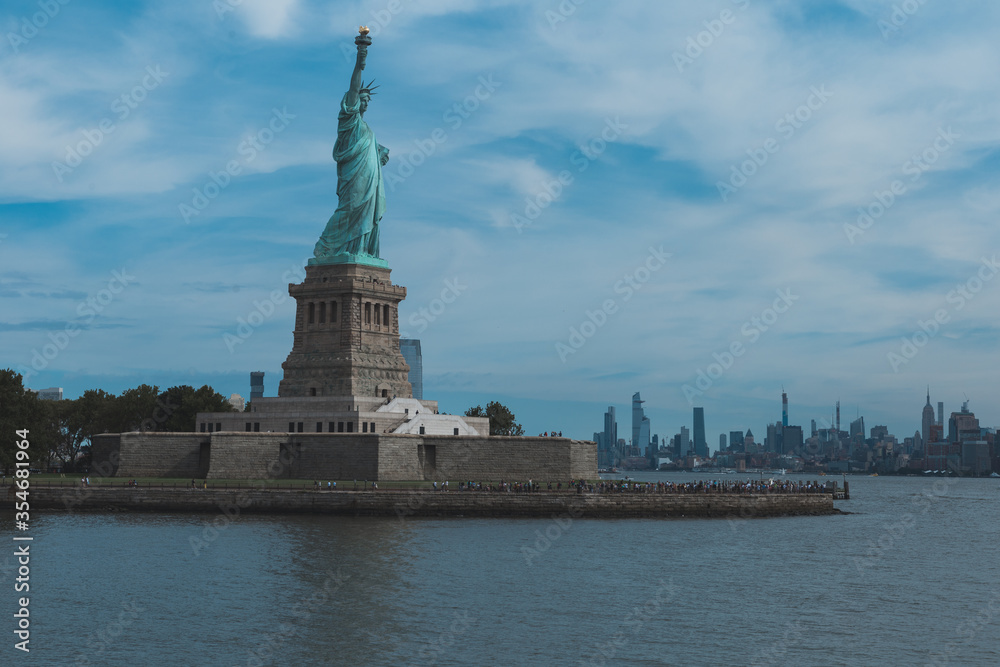 statue of liberty new york city wth skysgrapers