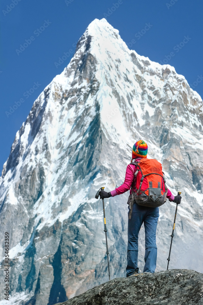 Hiking in Himalaya mountains. Nepal, Sagarmatha national park. Woman Traveler with Backpack hiking in the Mountains. mountaineering sport lifestyle concept Hiking in Himalaya mountains. Nepal, Sagarmatha national park. Woman Traveler with Backpack hiking in the Mountains. mountaineering sport lifestyle concept