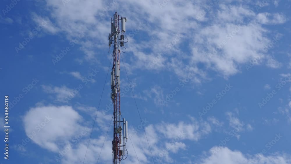 An engineer of a mobile company serves a mobile transmission station. 5g cellular coverage. High-altitude work. An engineer of a mobile company serves a mobile transmission station. 5g cellular coverage. High-altitude work.