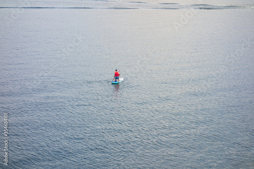 Man practicing paddle surf in the "San Juan" reservoir in Madrid, Spain