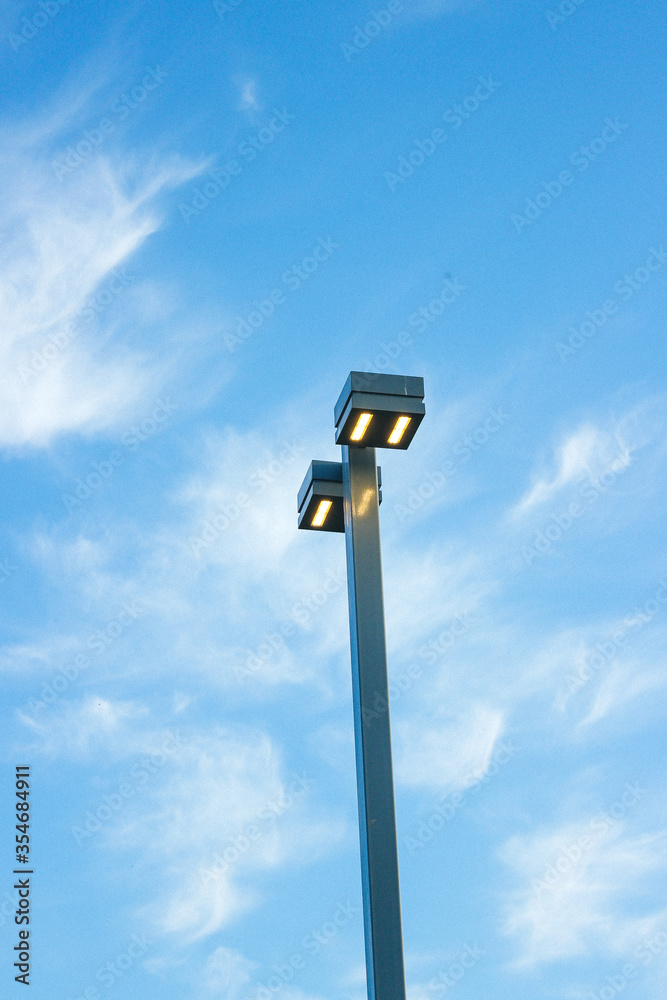 Modern lantern post against the blue sky
