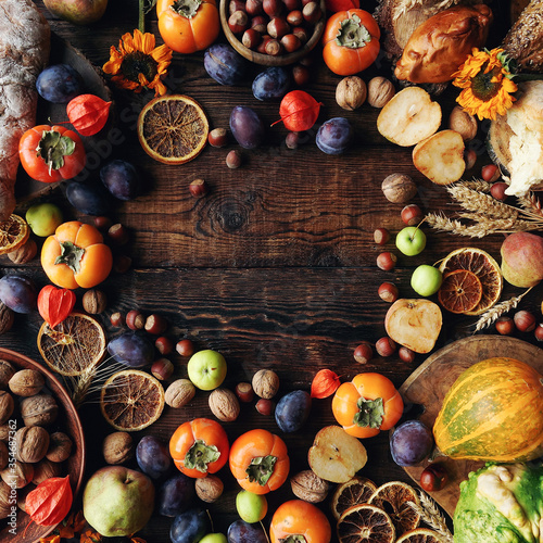 Autumn still-life composition with fresh fruits and vegetables on rustic wooden table