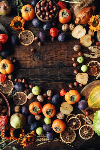 Autumn still-life composition with fresh fruits and vegetables on rustic wooden table