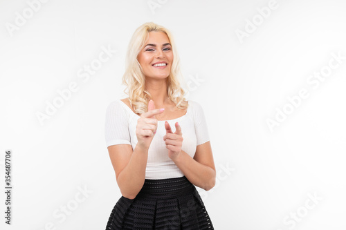 smiling girl in a white t-shirt shows a super class on a white background with copy space