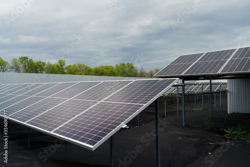 Sun solar panels electricity sustainability of planet. Green energy for home. Solar cells power plant business. Ecological clean energy. Blue panels on the ground.