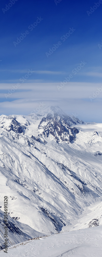 High snowy mountains and blue sky with clouds High snowy mountains and blue sky with clouds