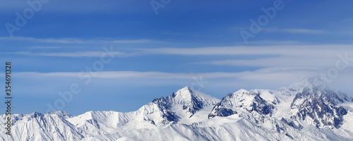 Panoramic view on high snowy mountains and blue sky with clouds © BSANI