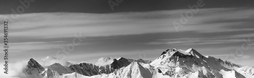 Black and white panoramic view on snowy mountains in winter
