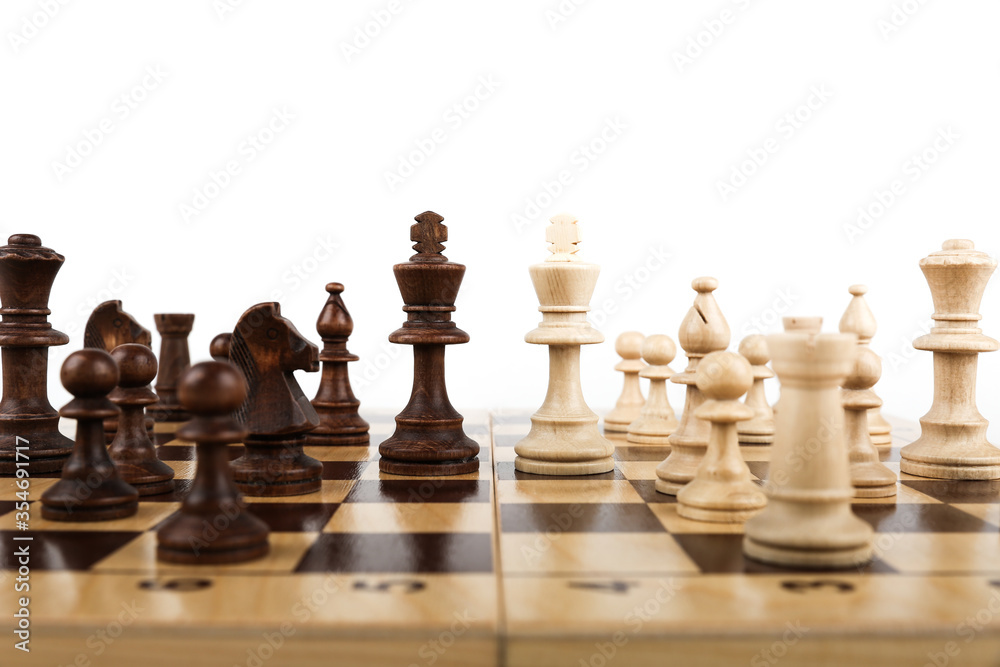 two kings and chess pieces on a chessboard on a white background. battle of kings on the battlefield