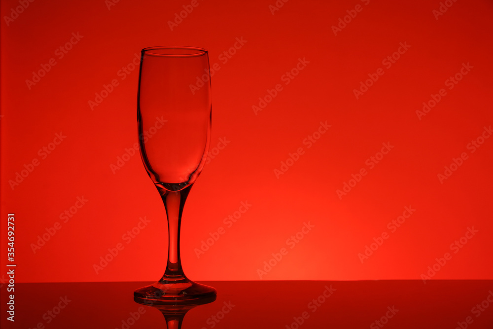 empty transparent wine glass on red background empty transparent wine glass on red background