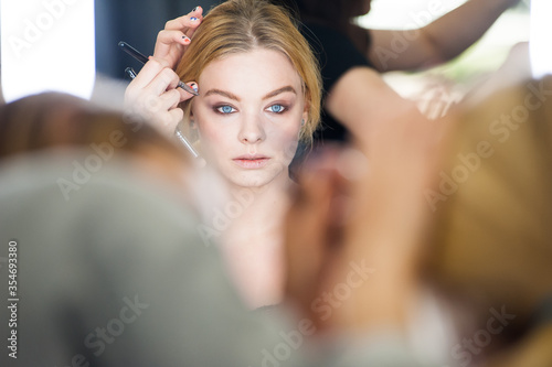 Professional makeup for a woman in a beauty studio