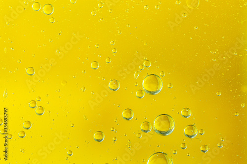 Golden yellow bubble oil or serum, Abstract Yellow water bubbles background