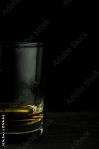 Glass of whiskey on a black background close up