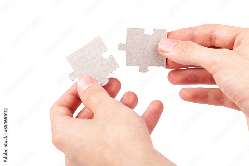 Man holding in hand puzzle element and looks for a solution to