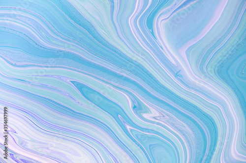 Fluid art texture. Backdrop with abstract swirling paint effect. Liquid acrylic picture with flows and splashes. Mixed paints for background or poster. Blue, lavander and mint overflowing colors