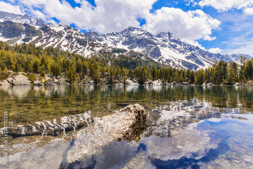 Beautiful mountain lake of Saoseo (Lagh da Saoseo or Lago di Saoseo) on a sunny afternoon in Val da Camp, a valley in the Poschiavo region of the Grisons, Switzerland. photo