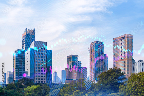 Forex and stock market chart hologram over panorama city view of Bangkok  the financial center in Asia. The concept of international trading. Double exposure.