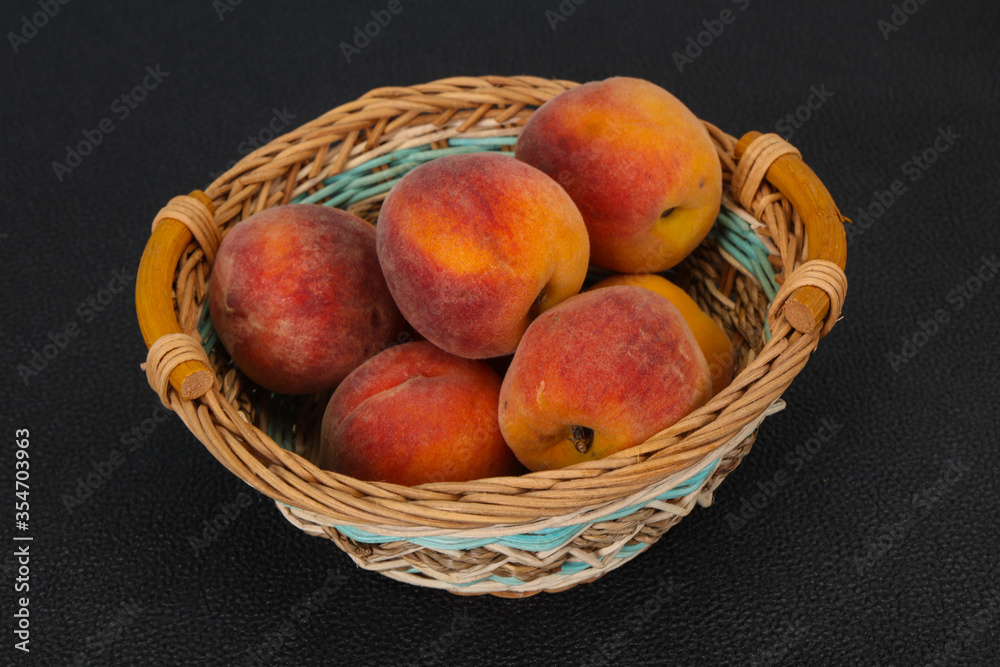 Peach heap in the wooden basket Peach heap in the wooden basket