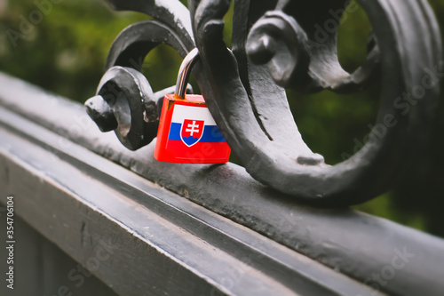 Photography A Slovak flag padlock is attached to a bridge in the style of a love lock