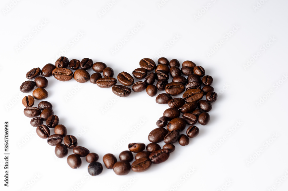 Heart folded with coffee beans on a light background Heart folded with coffee beans on a light background