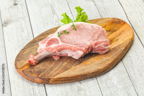 Raw pork bone steak over wooden