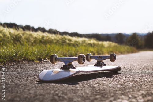Skateboard is on the street in good weather - 1