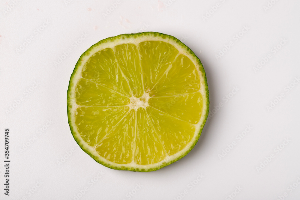 slice of lime over white background slice of lime over white background