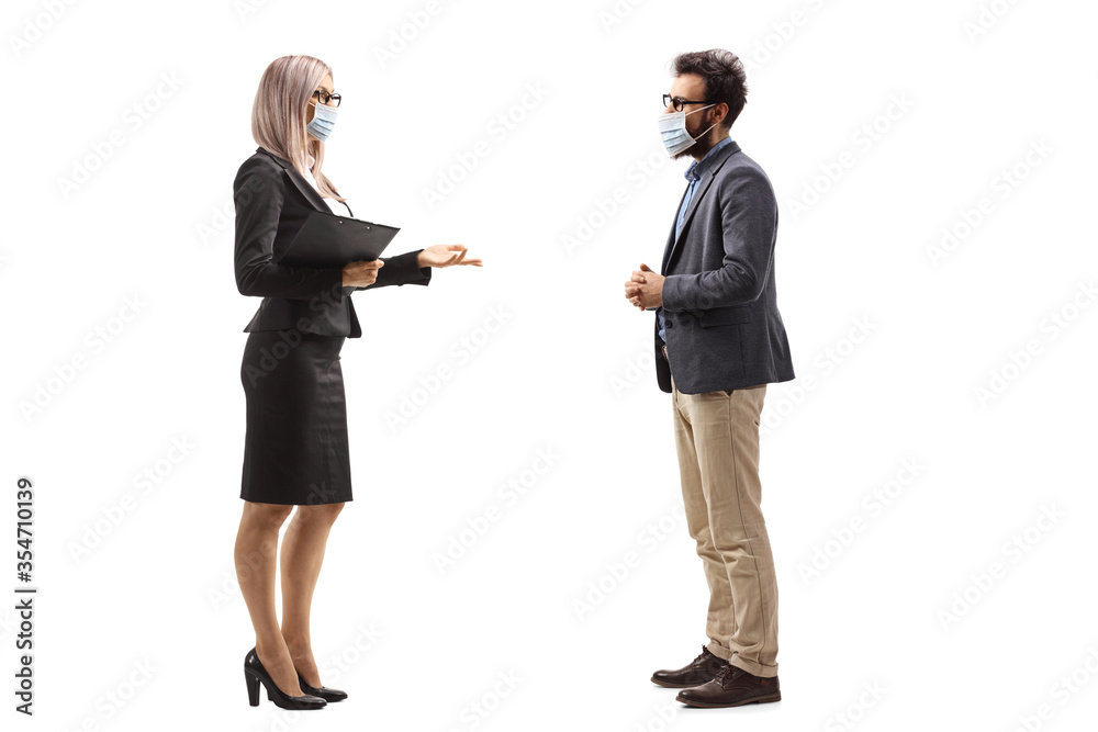 Businesswoman talking to a male colleague and wearing protective face masks Businesswoman talking to a male colleague and wearing protective face masks