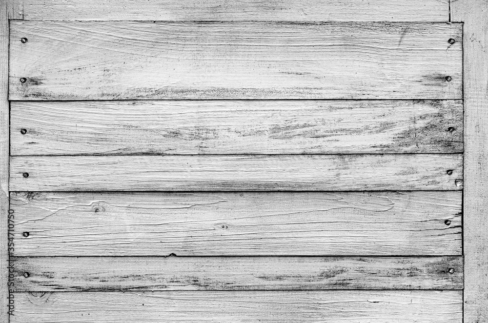 Naklejka premium Wooden shield made of several horizontal boards in black and white. Place for text, rustic background