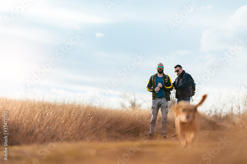 Happy friends walking with a dog